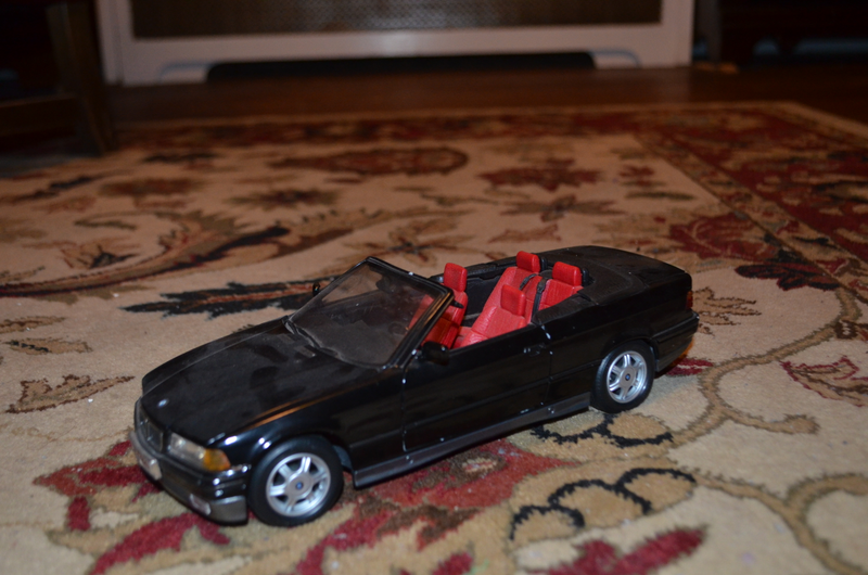 1/18 BMW 3-series convertible with working top & pop-up rollover protection. Top material seems to have semi-permanent wrinkles but otherwise only dusty.